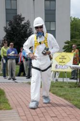Andy Kulik models a Tyvek® suit, half-face air purifying respirator, fall protection harness, hard hat, hearing protection, and 4 gas meter.
